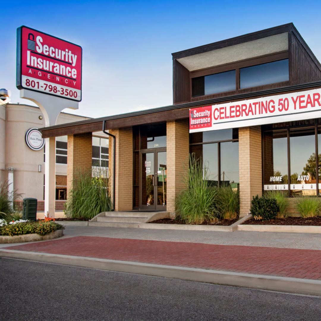 Family standing in front of their home with their dog